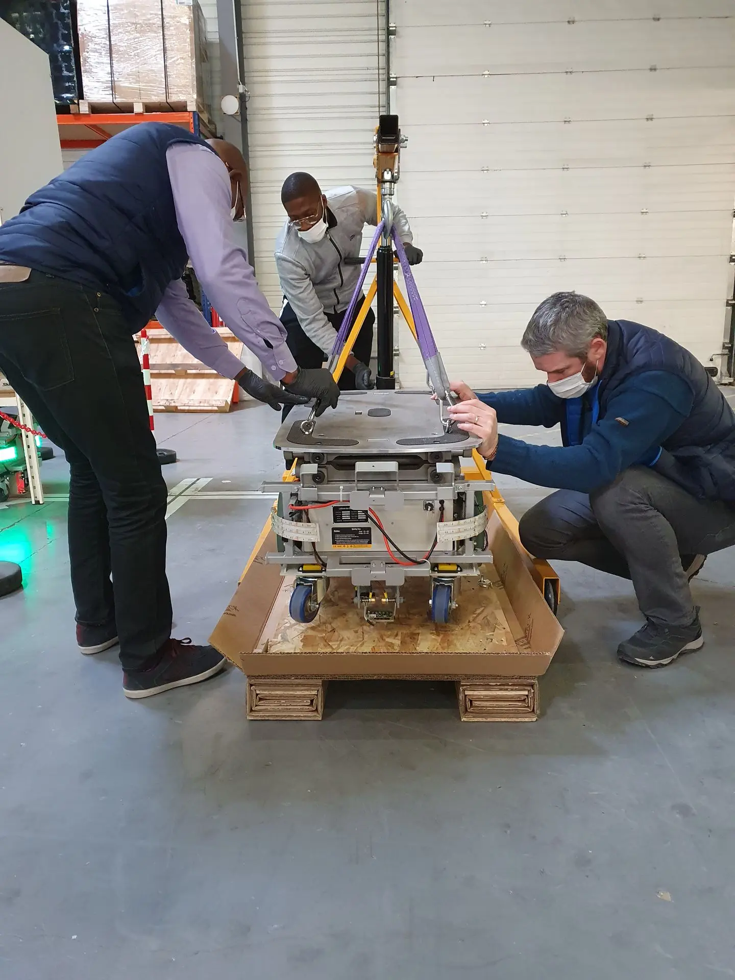 chargement d'une machine à l'interieur de la caisse